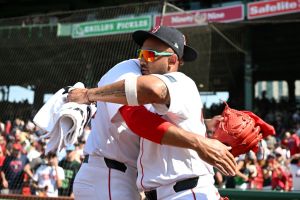Jamie Westbrook #73 of the Boston Red Sox hugs Brennan Bernardino #83 after a game against the Atlanta Braves. Father's Day at Fenway park