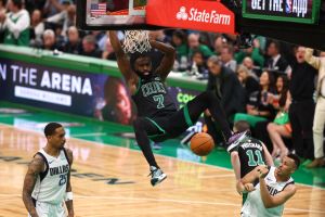 Jaylen Brown #7 of the Boston Celtics dunks the ball against the Dallas Mavericks . Jaylen Brown's sneakers are green and purple