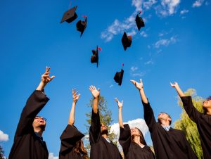 Graduates throwing their caps into the air. The numbers are in and research has been conducted, and now, we have information on Florida graduation rates for high school and how they stack up to other states.