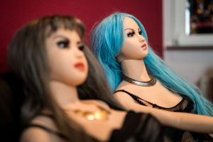 Two sex dolls sitting up. A TikTok video shows a guy on a date with a blow up doll!