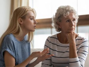 Annoyed blonde grown up daughter arguing with stubborn mature mom.