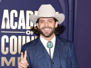 Thomas Rhett in a denim suit and cowboy hat.
